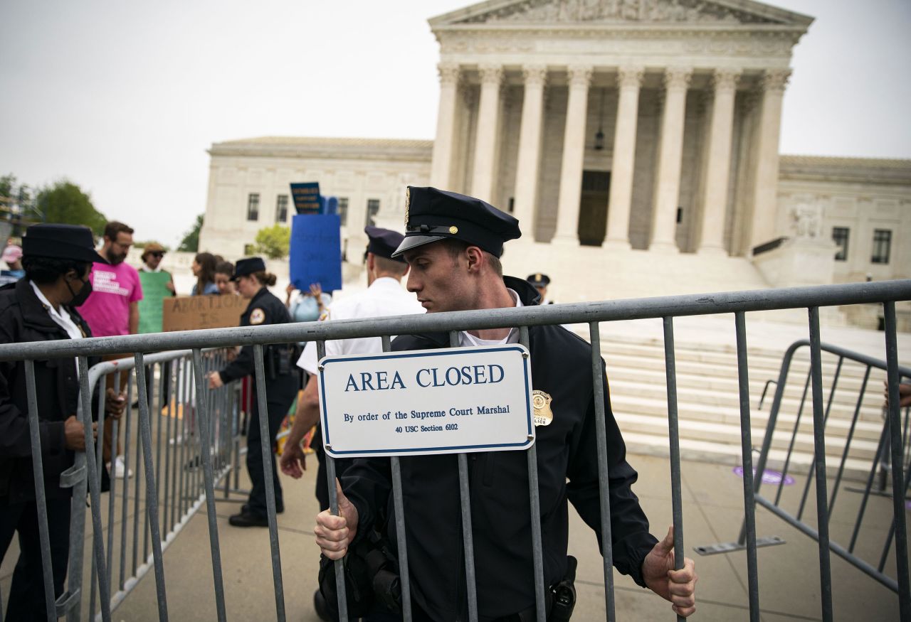 A police officer sets up a barricade during a protest outside of the US Supreme Court in Washington, DC, on Tuesday.