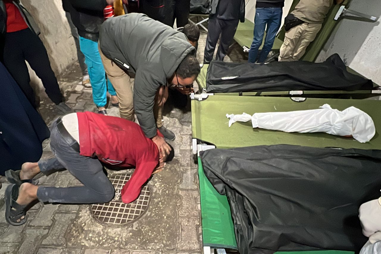 A man mourns by the shrouded body of a Palestinian child killed in an Israeli airstrike in Rafah, on May 7. 