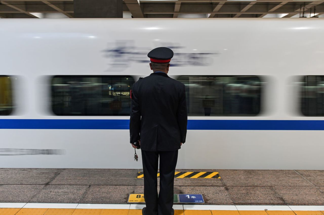 A controller stands by as one of the first trains to leave the city after an outbound travel ban was lifted departs Hankou Railway Station in Wuhan, in China's central Hubei province, early on April 8.