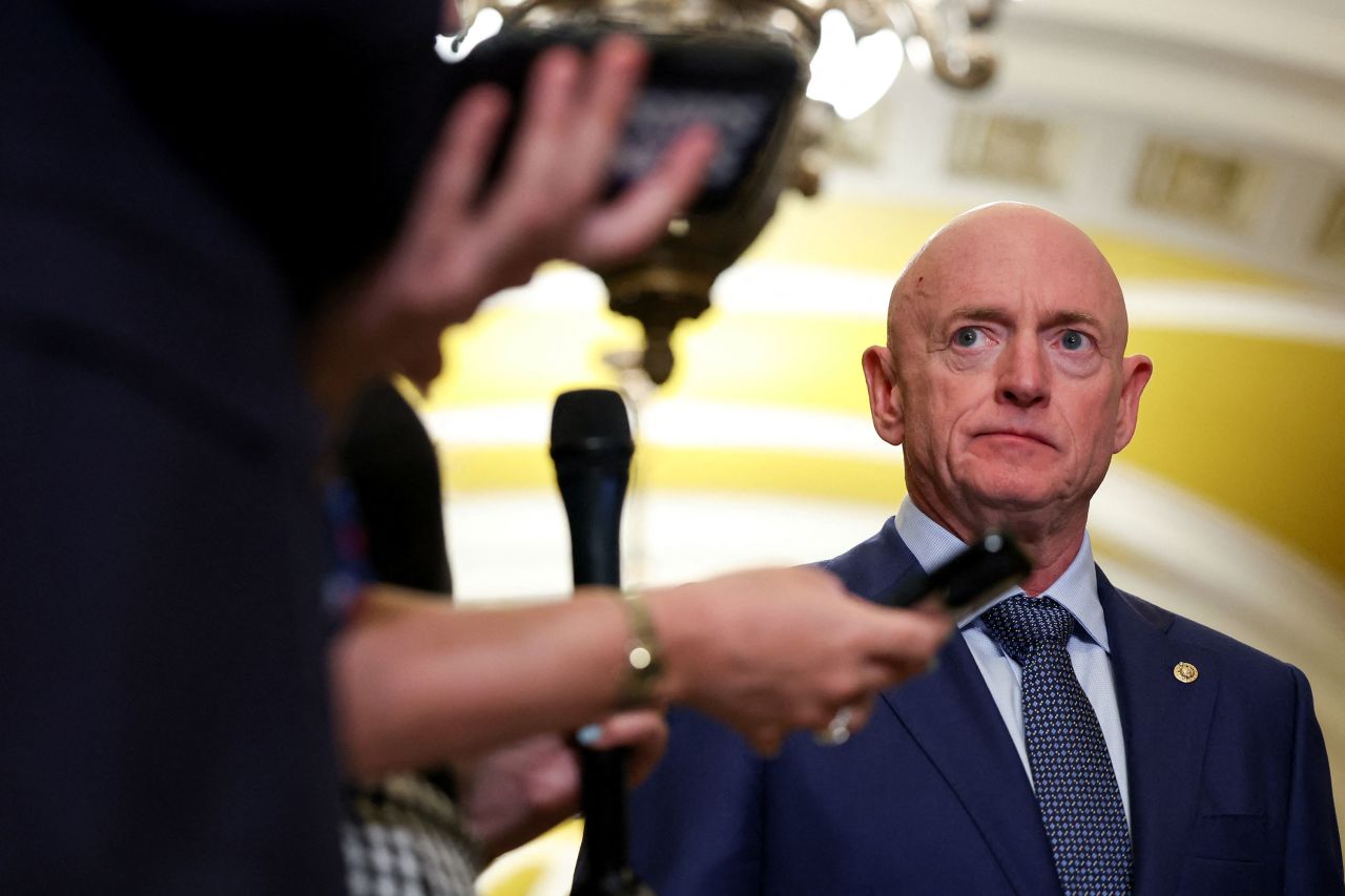 Sen. Mark Kelly looks at reporters during a press conference on Capitol Hill in April.