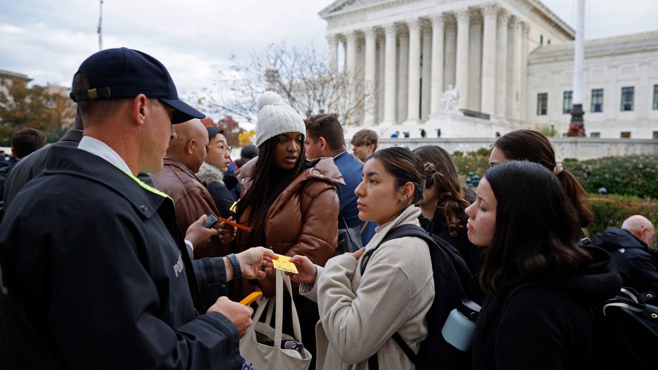 Supreme Court Police hand out tickets to members of the public so that they can attend oral arguments on Monday.