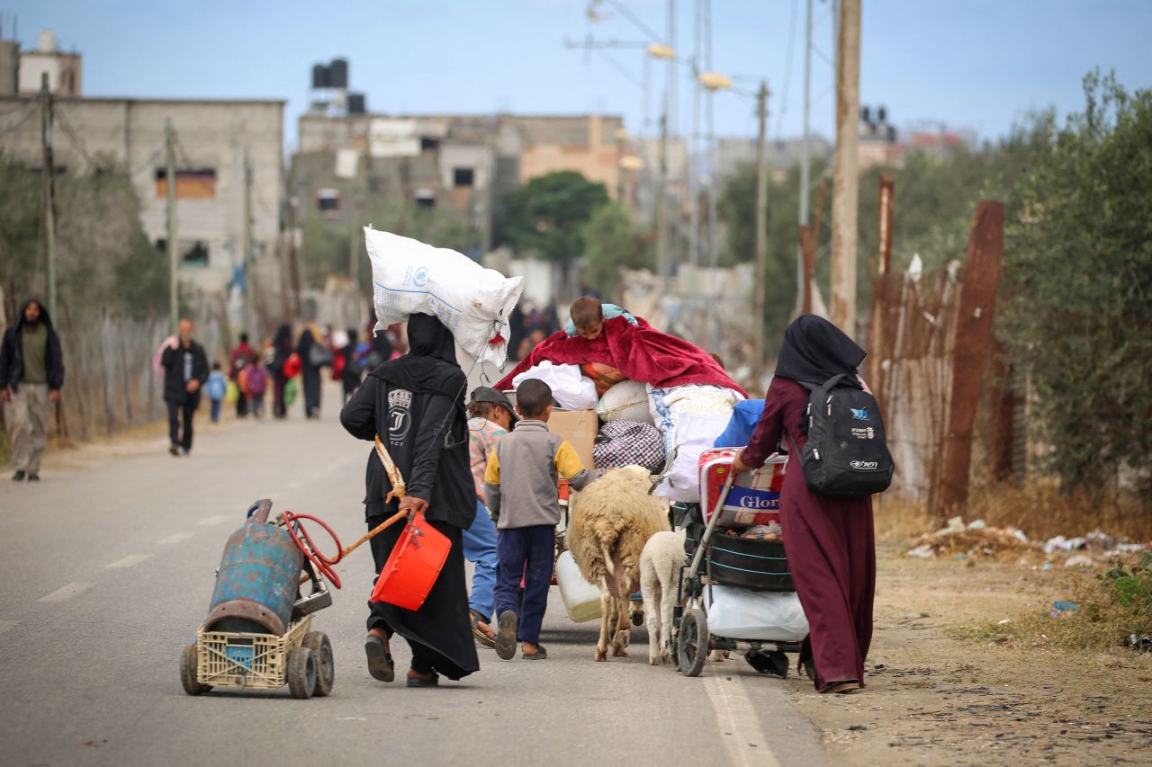 Displaced Palestinians carry their belongings as they leave Rafah following an evacuation order by the Israeli army on May 6. 