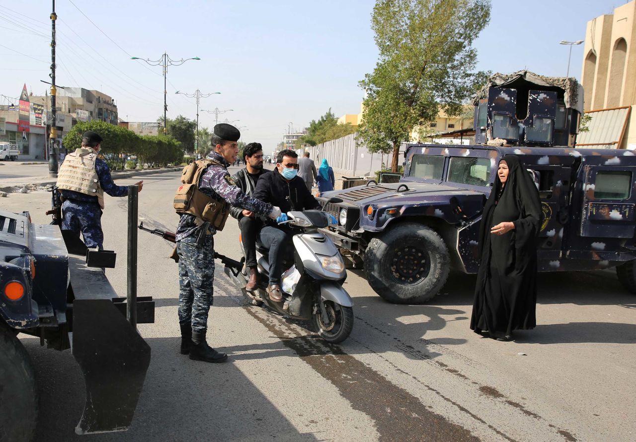 Iraqi police work at a checkpoint in Baghdad, Iraq, on March 24.