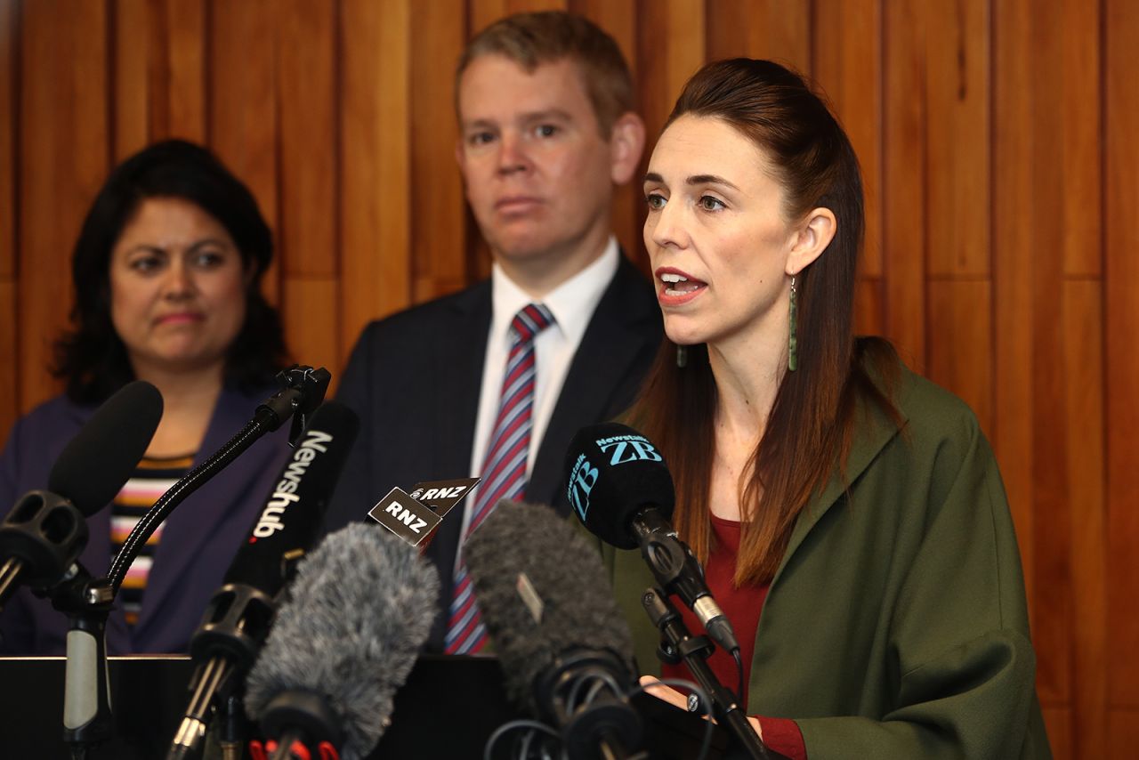 New Zealand Prime Minister Jacinda Ardern (right) and Minister for Covid-19 Response Chris Hipkins (center) speak to the media at Auckland University in New Zealand, on December 17.