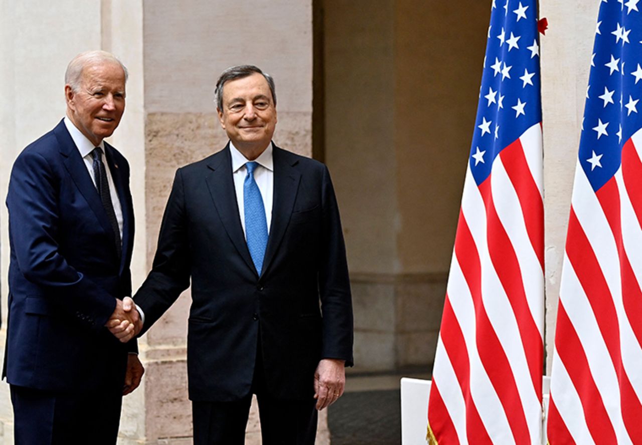 Italy's Prime Minister, Mario Draghi (R) greets US President Joe Biden upon his arrival for their meeting at the Chigi palace in Rome on October 29, 2021