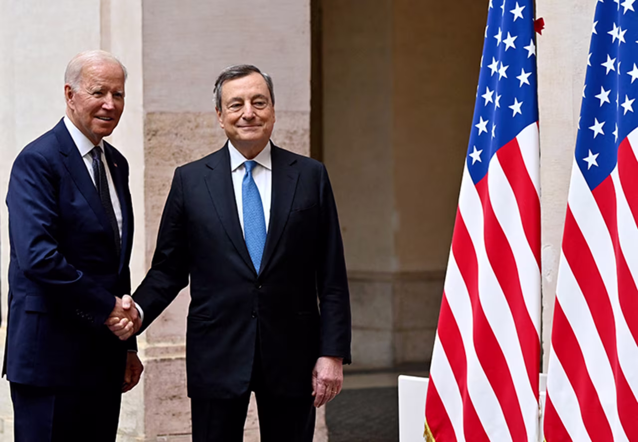 Italy's Prime Minister, Mario Draghi (R) greets US President Joe Biden upon his arrival for their meeting at the Chigi palace in Rome on October 29, 2021