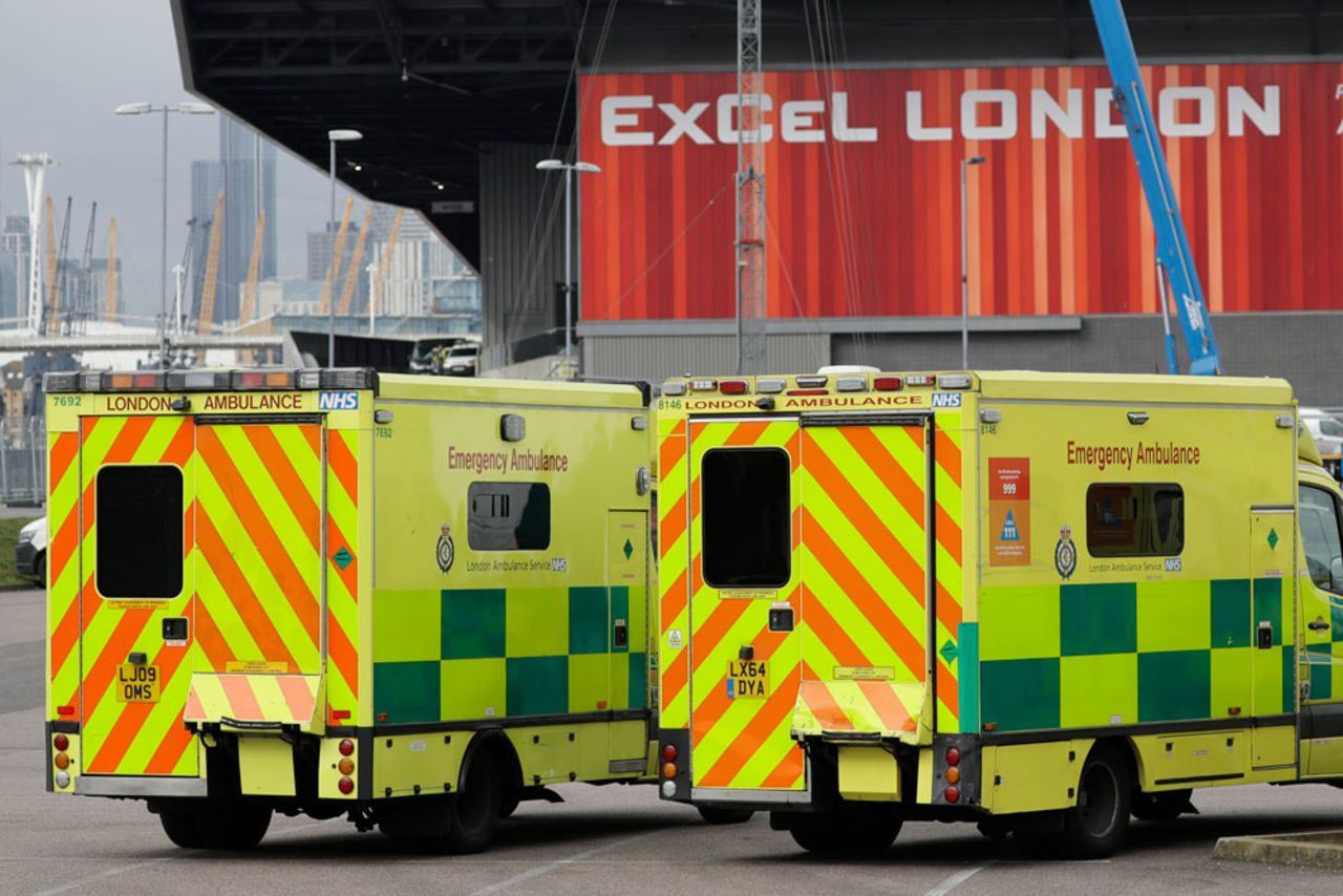 In this Monday, March 30 file photo, a line of ambulances stands outside the ExCel center, which is being turned into a 4,000-bed temporary hospital called NHS Nightingale to deal with coronavirus patients in London.