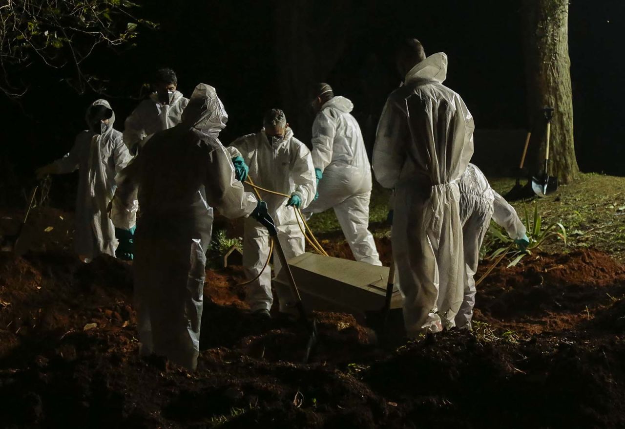 A coffin is buried at the Vila Formosa cemetery in Sao Paulo, Brazil, on March 31.