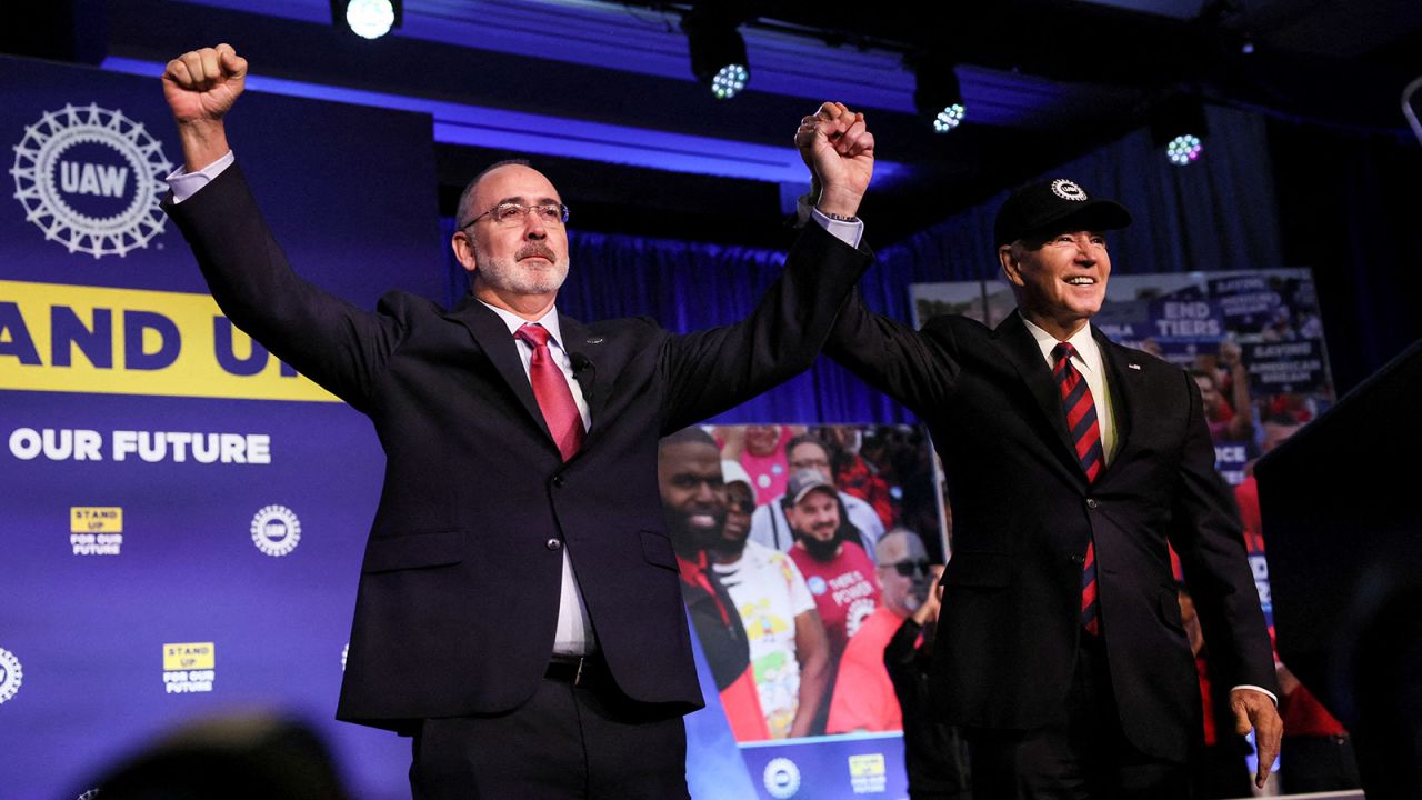 President Joe Biden holds hands with United Auto Workers President Shawn Fain after Fain and the UAW endorsed Biden for president on January 24.