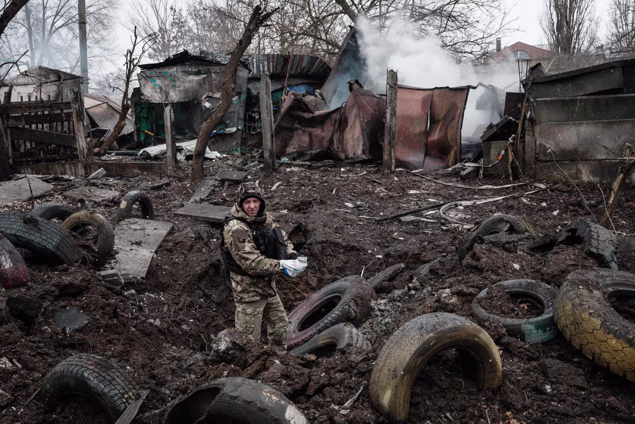 A police officer inspects a hole after a rocket strike, in Kramatorsk, Ukraine, on February 2.