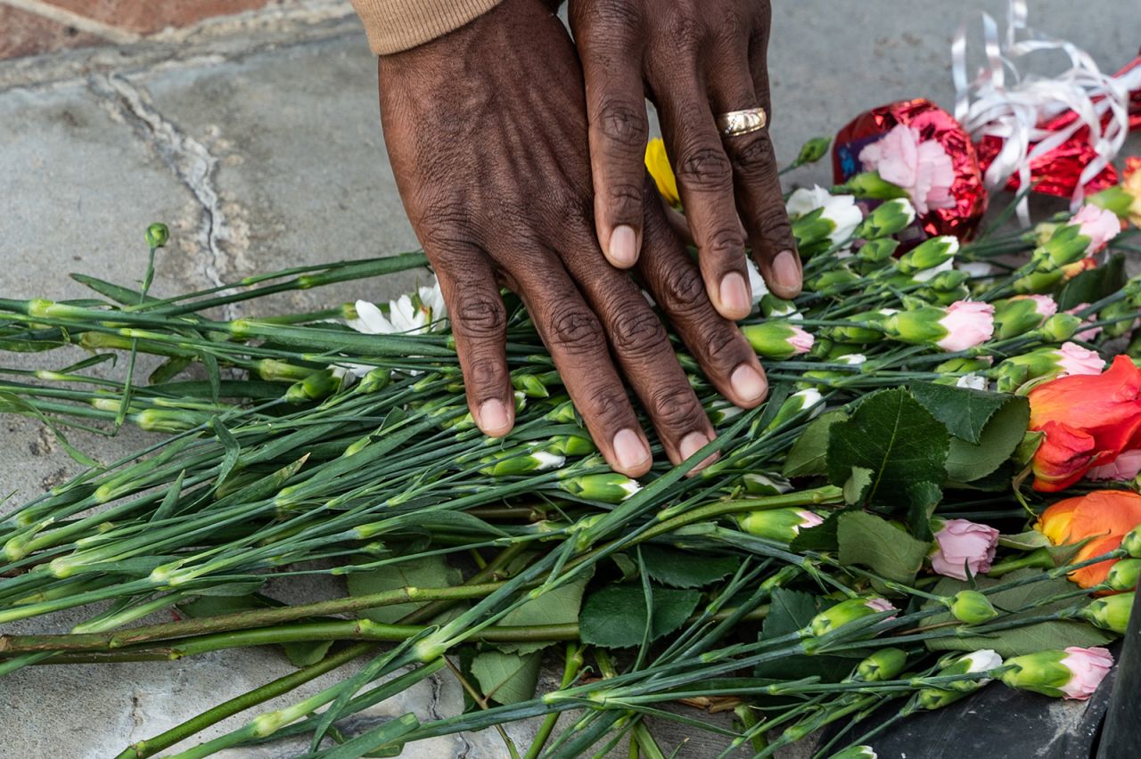 People place flowers at a memorial in Monterey Park, California on January 22.