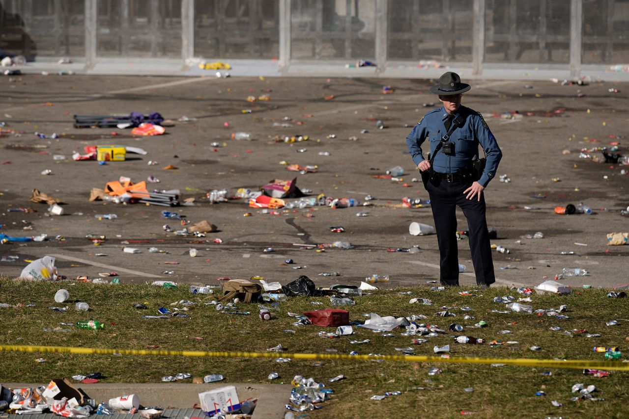 A law enforcement officer looks around the scene after the shooting.