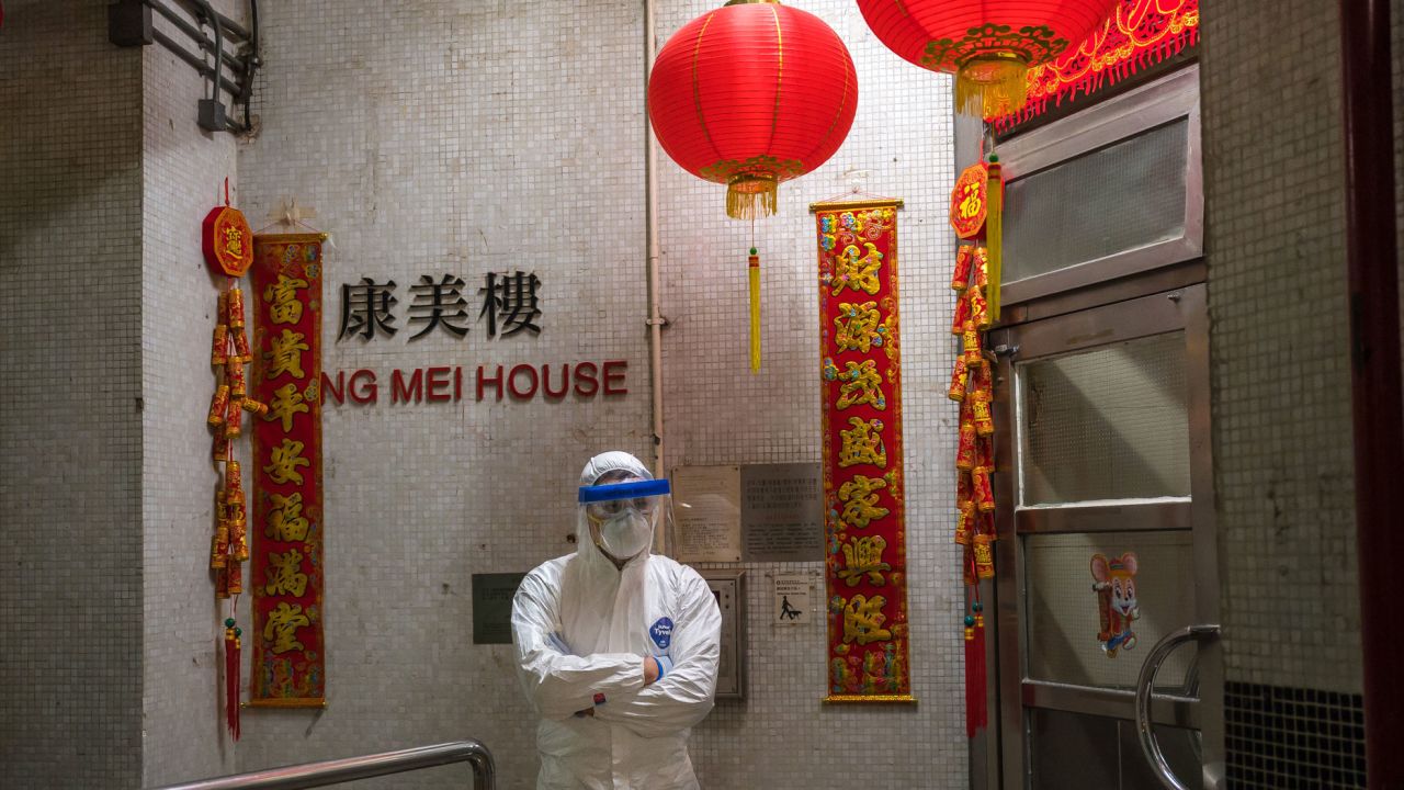 An official stands guard at an entrance to the Hong Mei House residential building in Hong Kong on Tuesday.