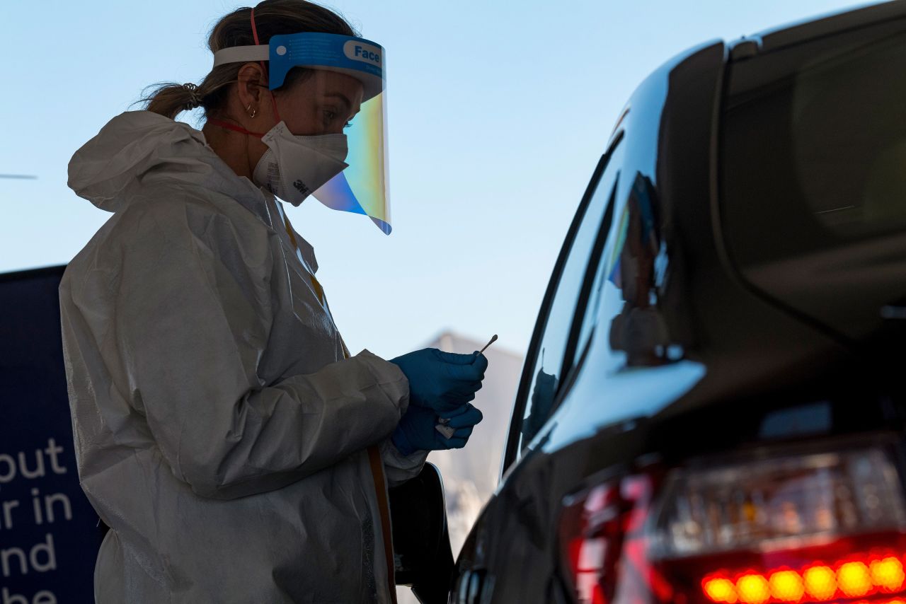 A health care worker in San Francisco administers a nasal swab test at a Covid-19 testing site on December 1.