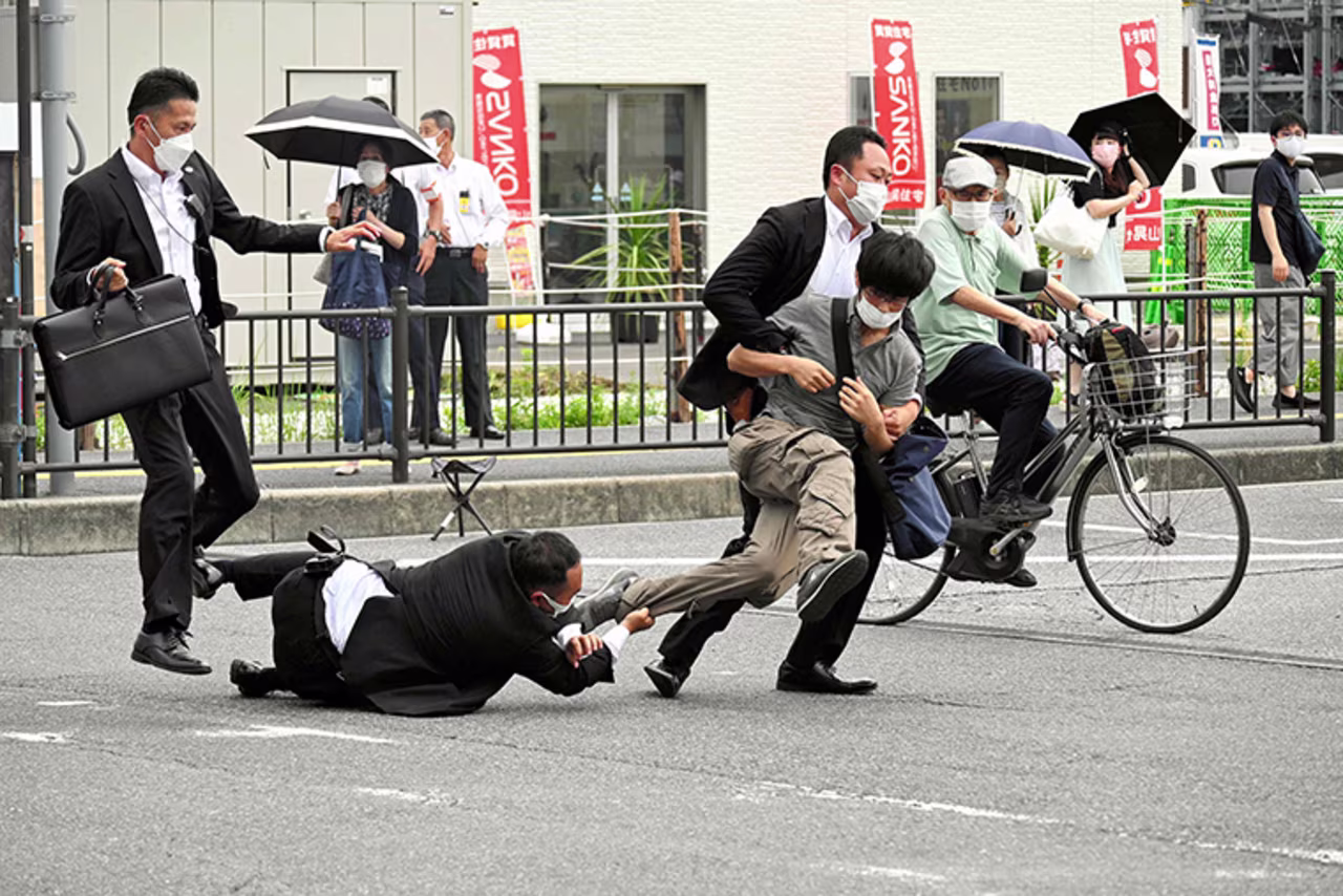 Security personnel detain Tetsuya Yamagami near the site where Shinzo Abe was shot in Nara, Japan, on July 8.