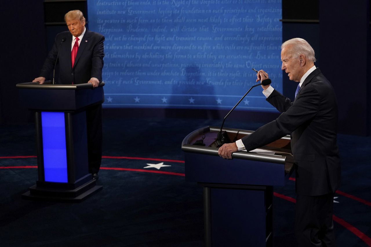 Democratic presidential candidate Joe Biden answers a question and President Donald Trump listens during the second and final presidential debate Thursday in Nashville.