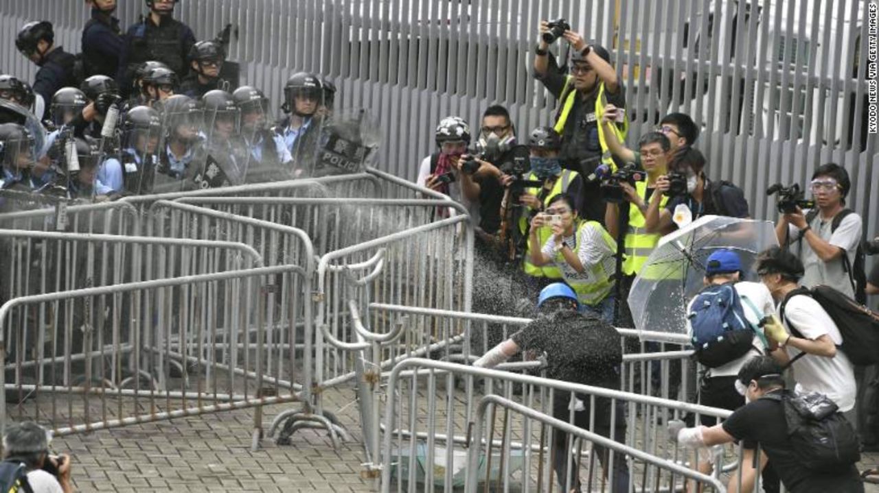 Police fire tear gas spray on protestors near Hong Kong’s legislature building. 