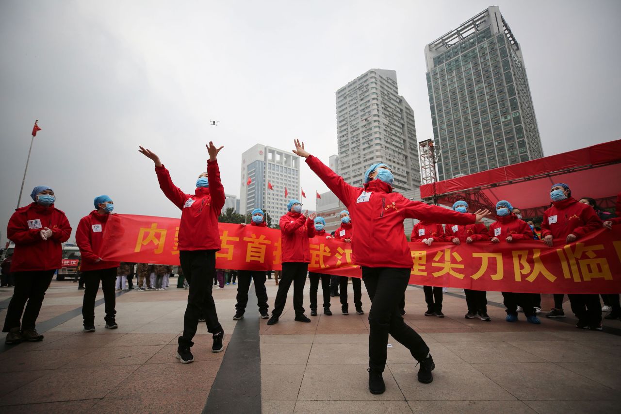 Medical staff celebrate after all patients were discharged from a temporary hospital on March 9 in Wuhan. 