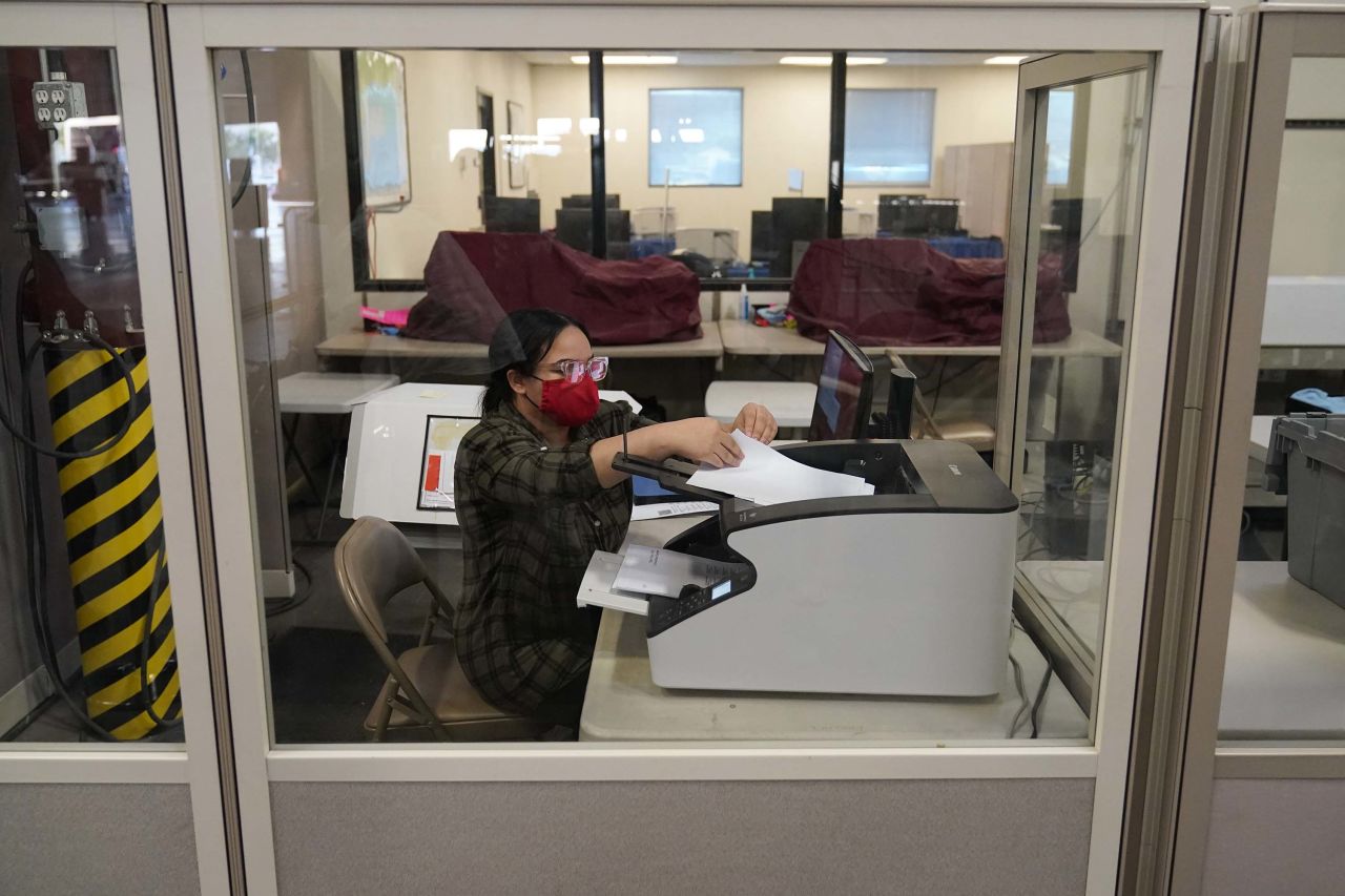 A county election worker scans ballots in a tabulating area at the Clark County Election Department, in Las Vegas, Nevada, on Wednesday, November 4.