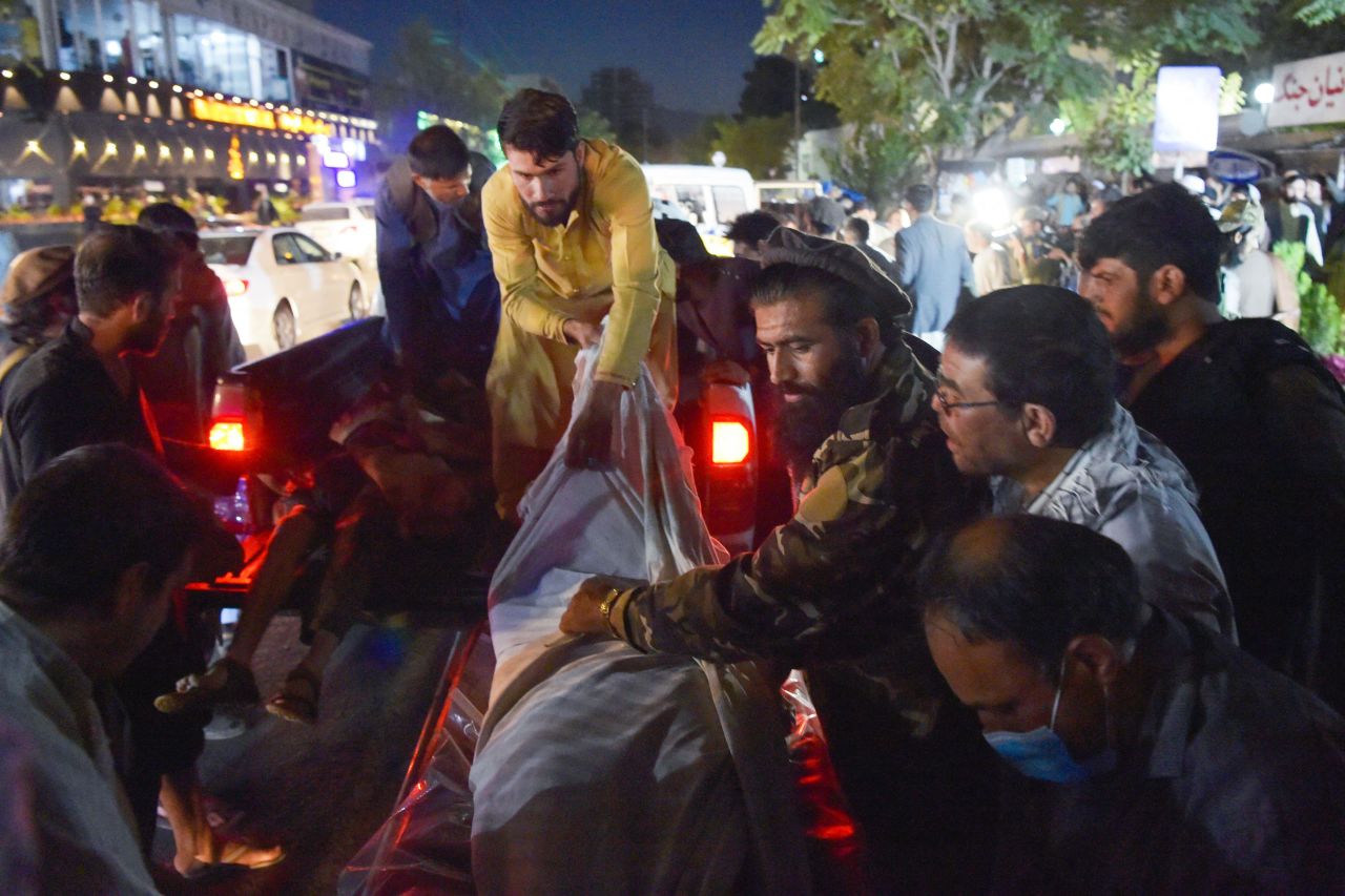 Volunteers and medical staff unload bodies at a hospital after a bomb blast in Kabul, Afghanistan, on August 26, 2021.