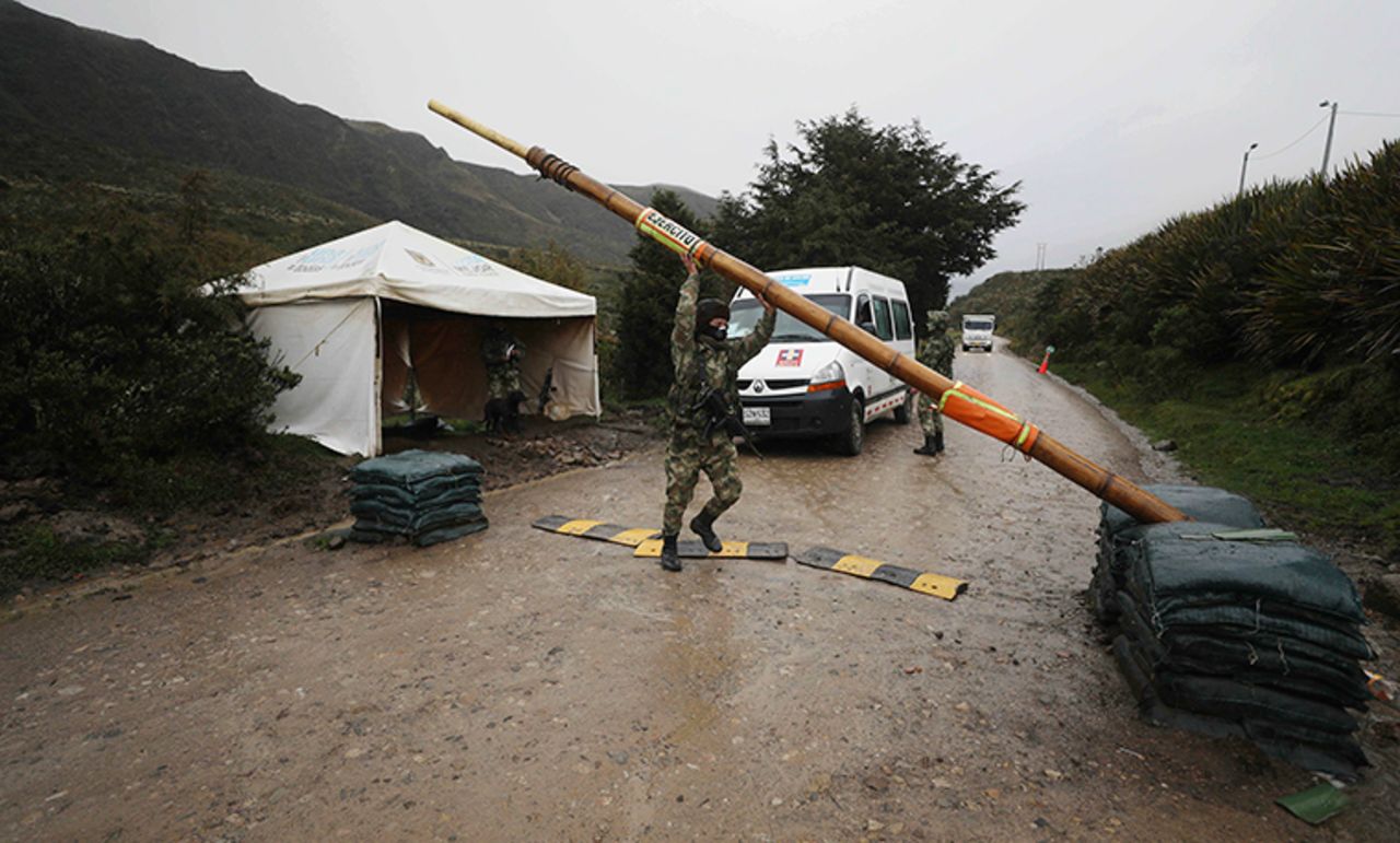 An ambulance is allowed to pass an army checkpoint, set up to monitor traffic, and help curb the spread of the new coronavirus near Usme, Colombia, Thursday, July 30. 