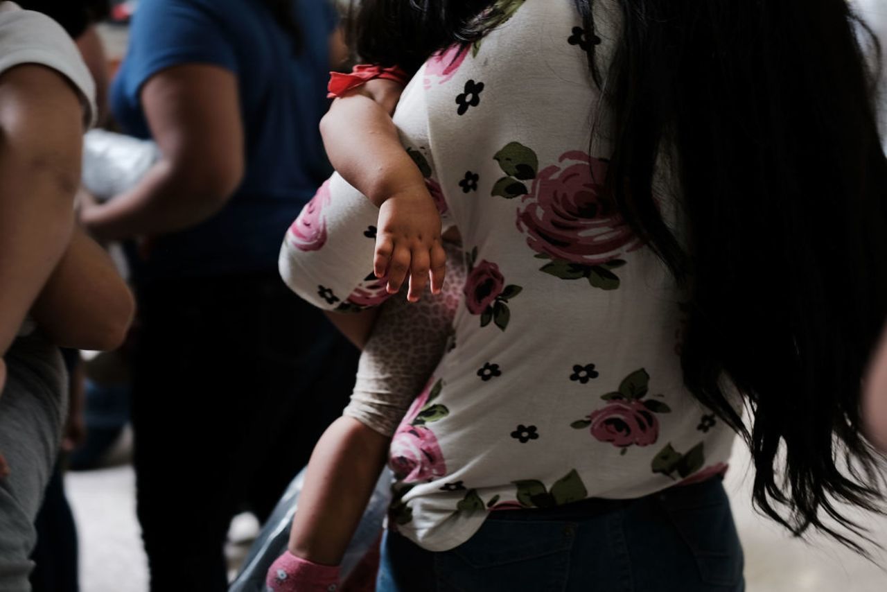 Dozens of women and their children, many fleeing poverty and violence in Honduras, Guatamala and El Salvador, arrive at a bus station following release from Customs and Border Protection on June 22, 2018 in McAllen, Texas.?