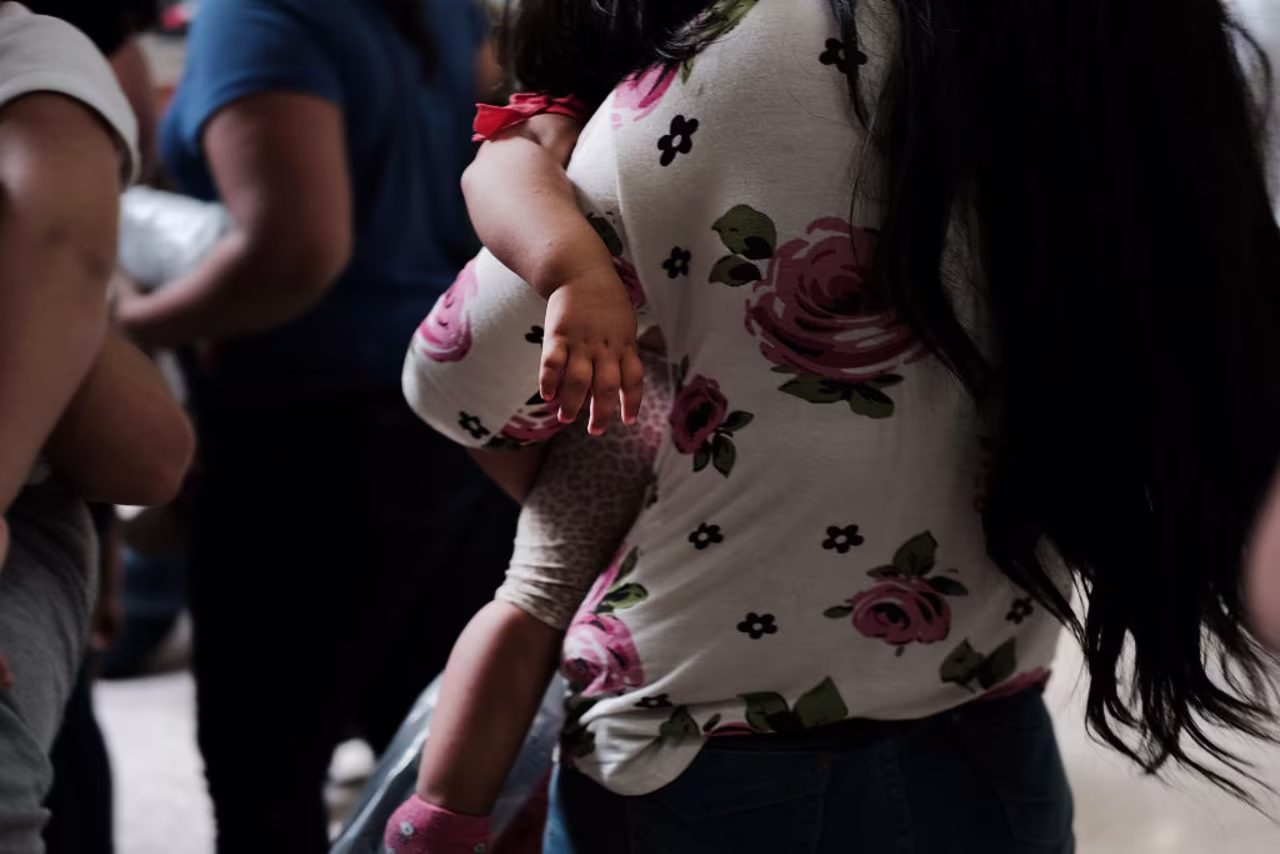 Dozens of women and their children, many fleeing poverty and violence in Honduras, Guatamala and El Salvador, arrive at a bus station following release from Customs and Border Protection on June 22, 2018 in McAllen, Texas. 