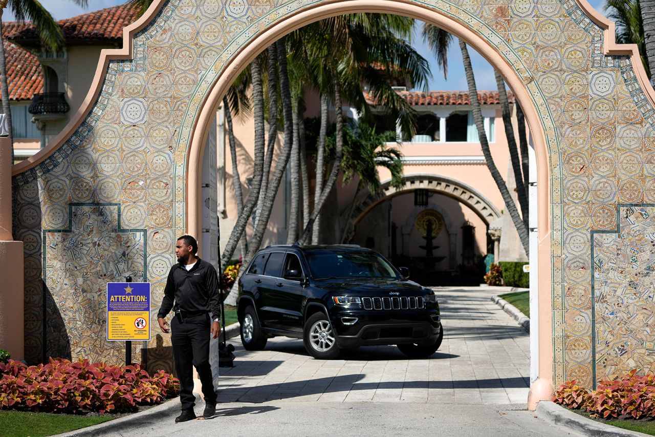 A security guard walks at the entrance to former President Donald Trump's Mar-a-Lago estate in Palm Beach, Florida.