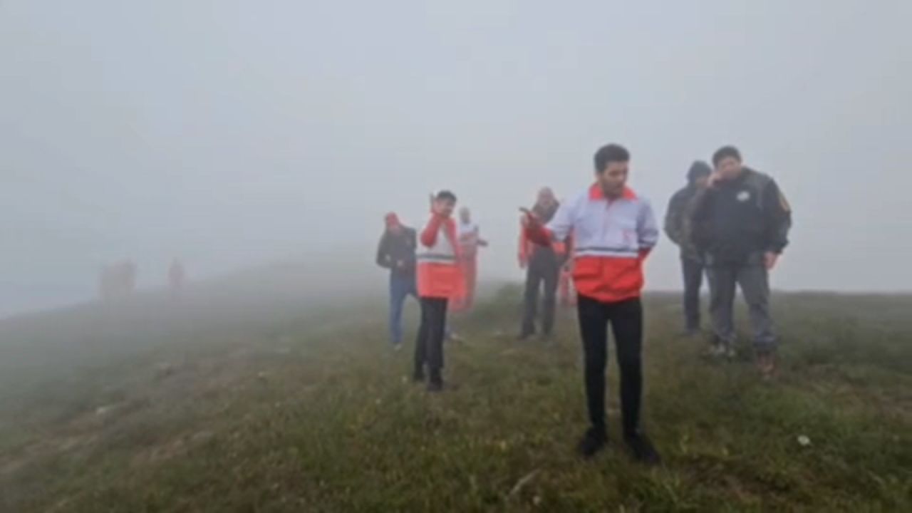 A screen grab from video released by Mehr News Agency via Telegram shows a rescue team arriving at the site of a helicopter crash in Iran on May 19.