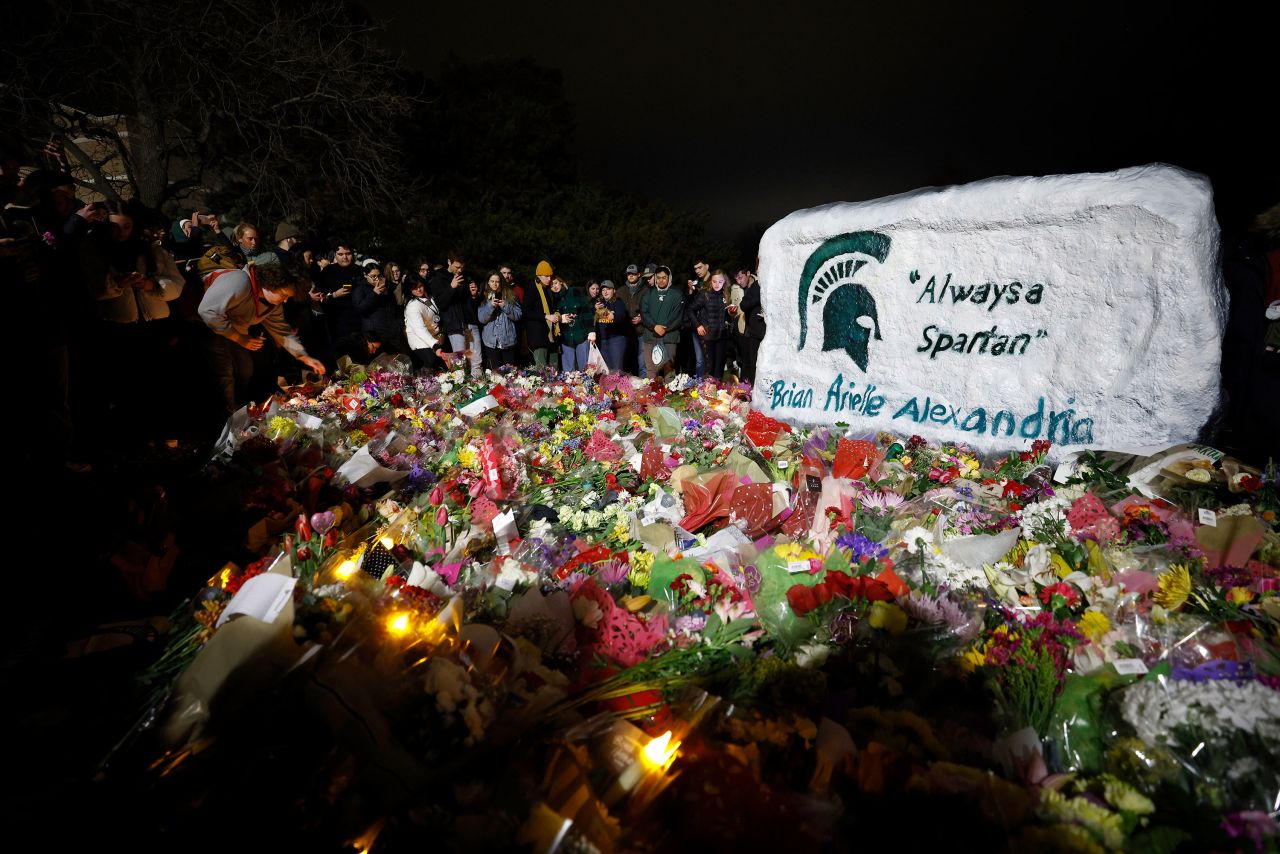 Mourners attend a vigil at The Rock at Michigan State University on Wednesday.