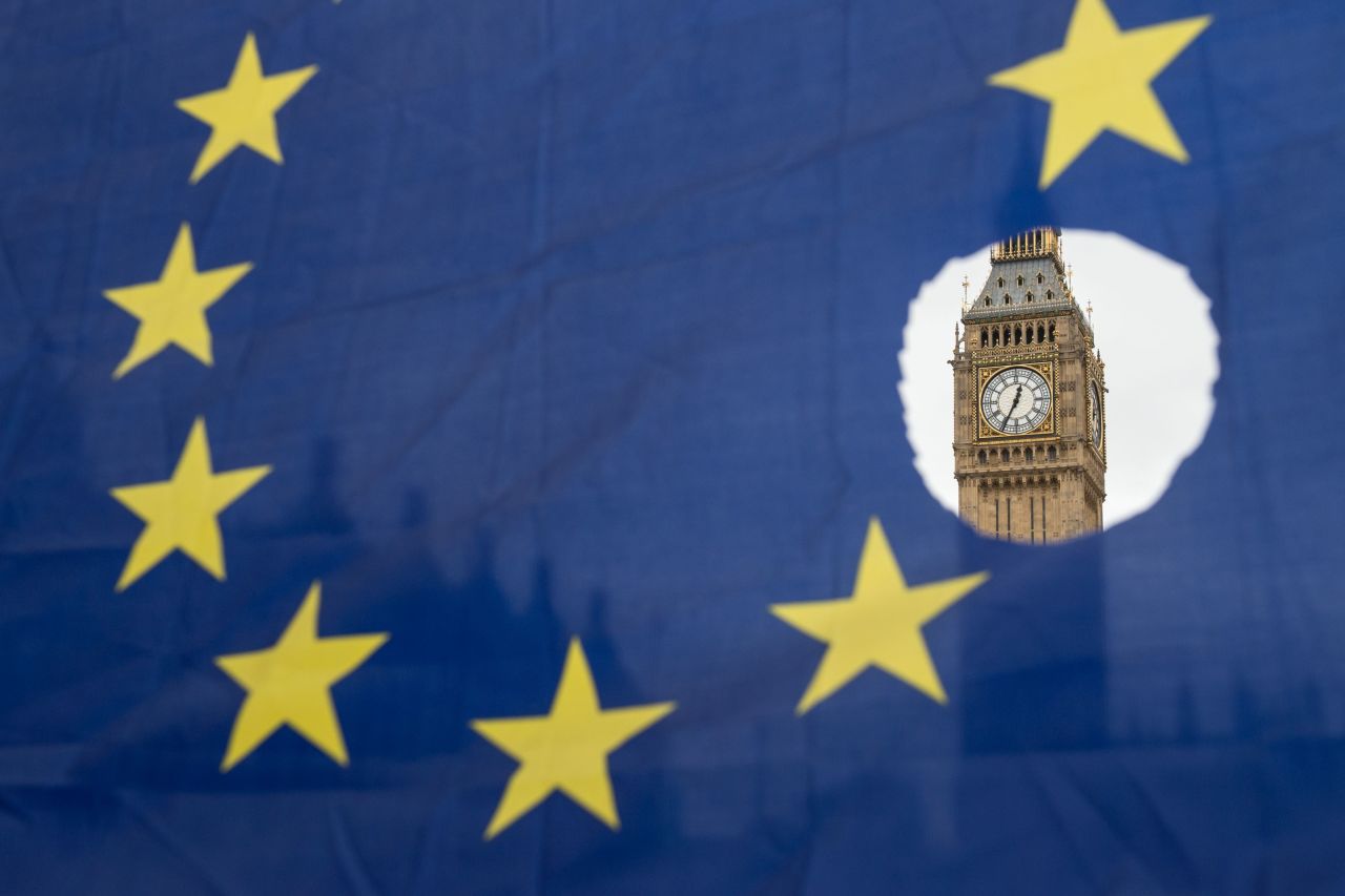 A pro-Remain protester holds up an EU flag with one of the stars symbolically cut out in front of the Houses of Parliament in 2017. 