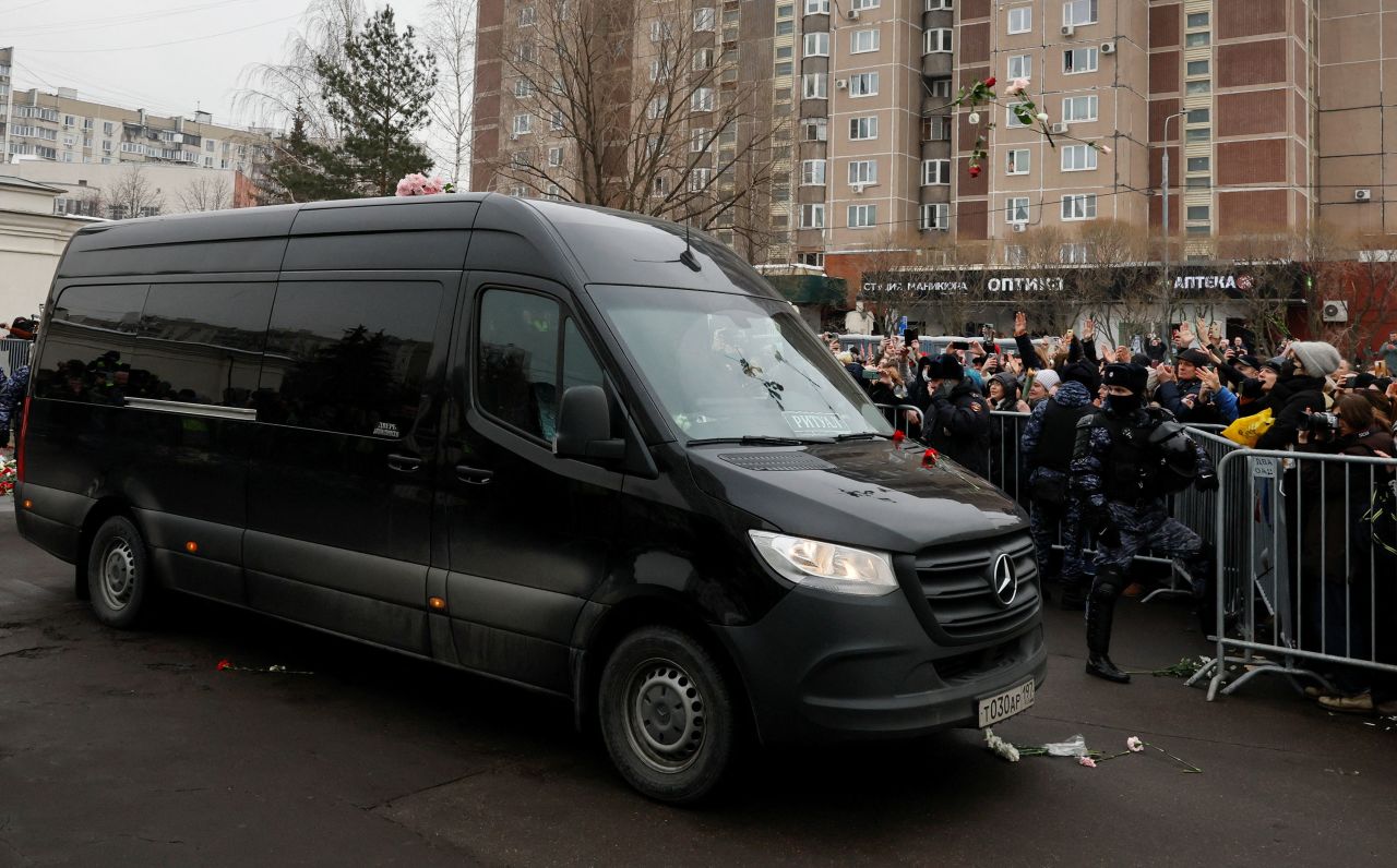 People throw flowers towards the hearse carrying Alexey Navalny's casket following the funeral service in Moscow on Friday.