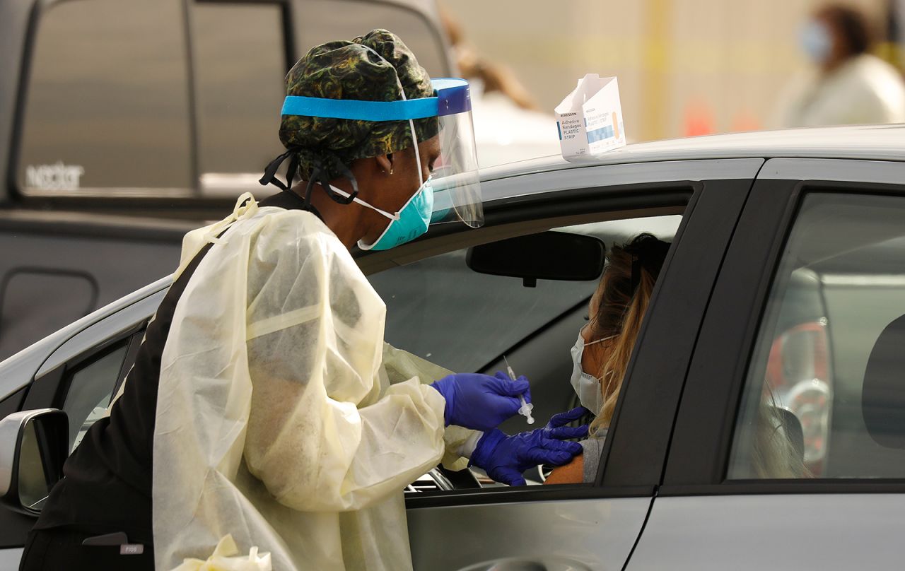 Staff and volunteers distribute the Covid-19 vaccine to people as they remain in their vehicles at The Forum in Inglewood, California, on, January 19.