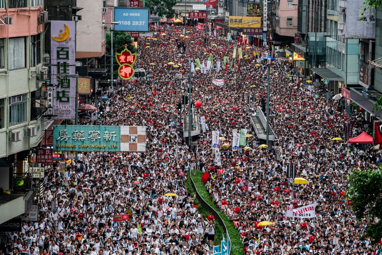 Protesters waved placards and wore white -- the designated color of the rally. "Hong Kong, never give up!" some chanted.