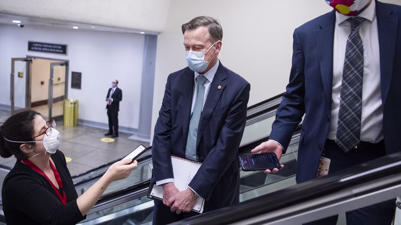 Sen. John Hickenlooper, D-Colo., is seen in the Capitol during a Senate vote on Thursday, March 11.