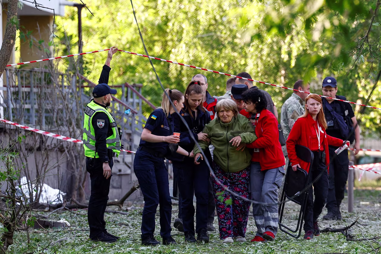 Emergency psychologists and paramedics support a woman, who identified the bodies of her daughter and granddaughter who were killed during a Russian missile strike in Kyiv, Ukraine on Thursday, June 1. 
