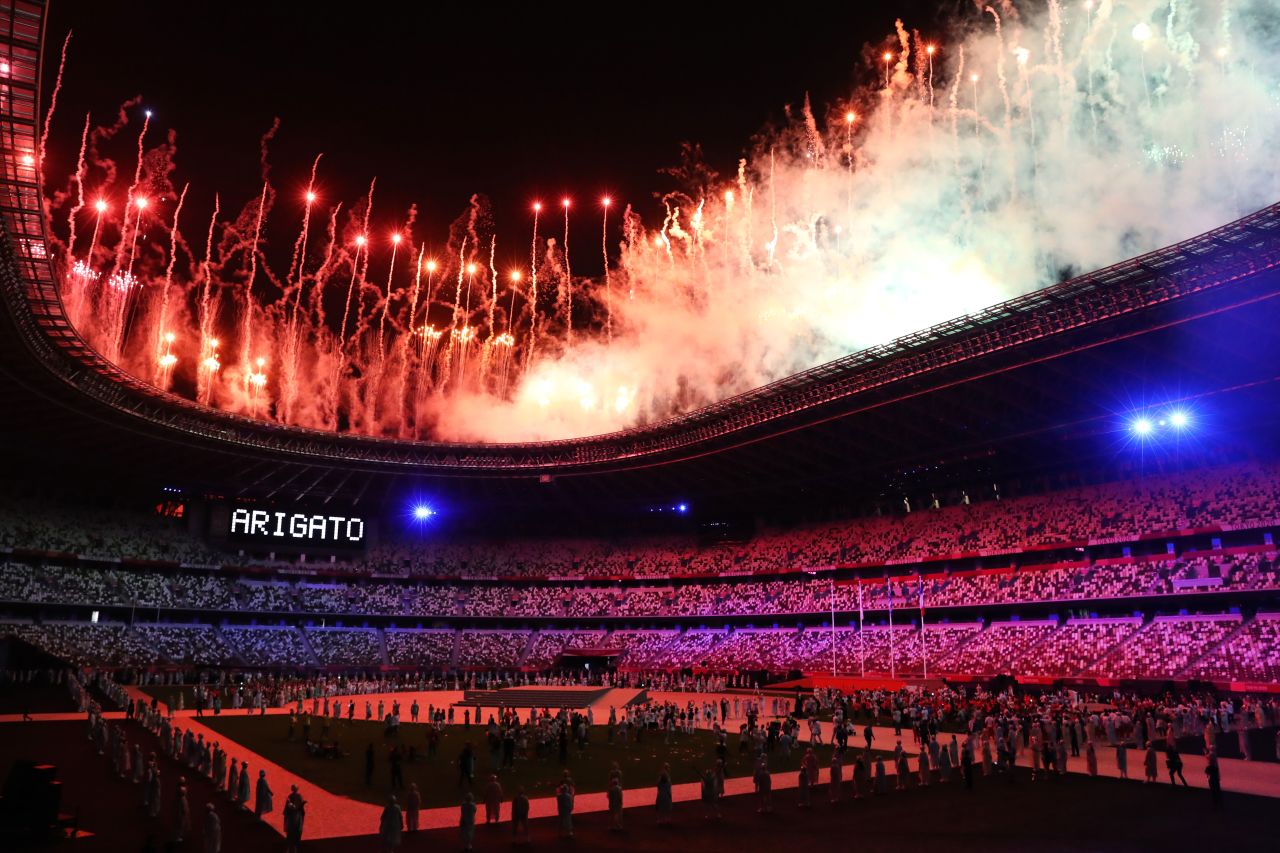 Fireworks explode over Tokyo's National Stadium at the end of the Olympics' closing ceremony on August 8. The word "arigato," seen at left, means thank you in Japanese.