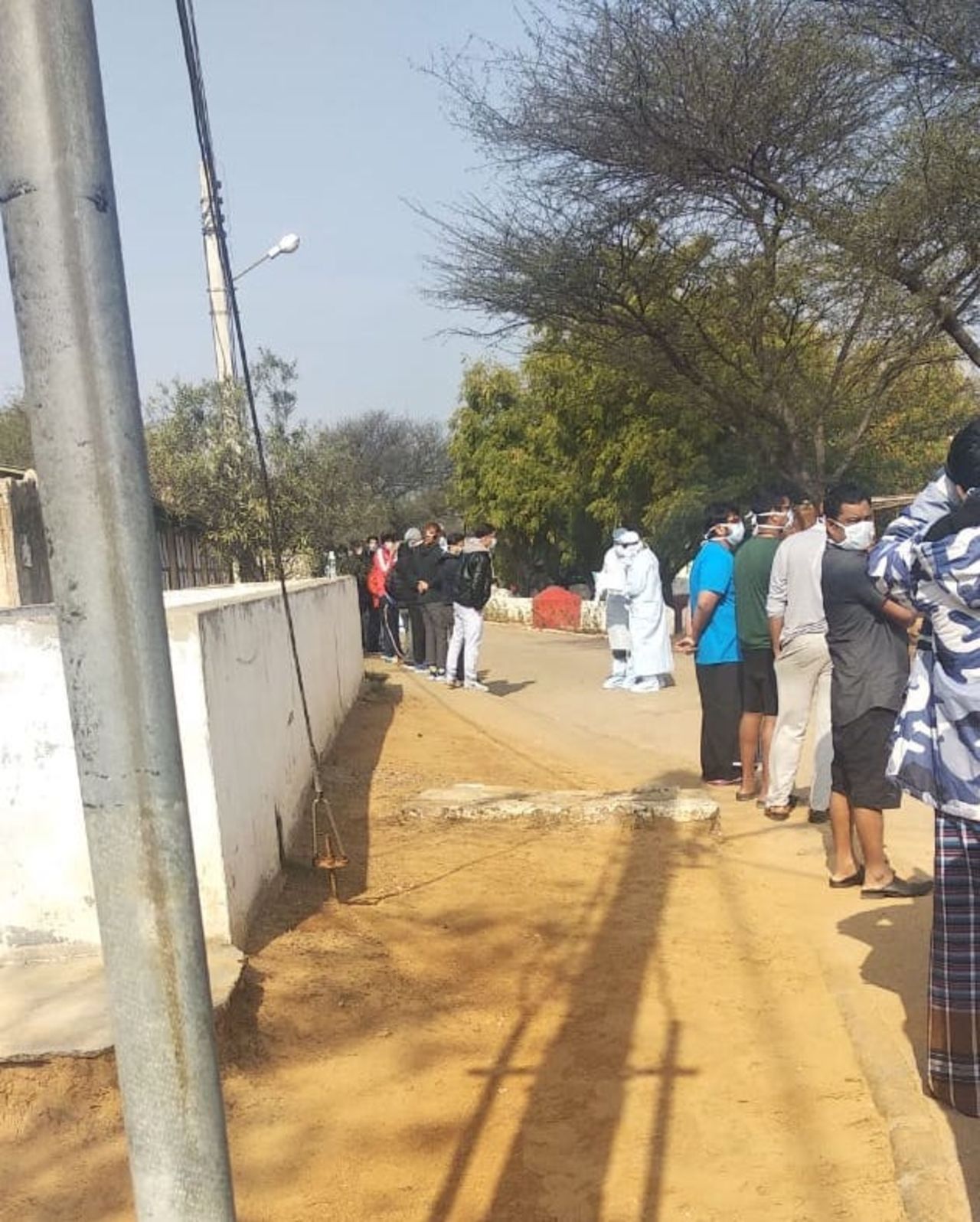 Indian returnees line up for a temperature reading at an army camp in Manesar.