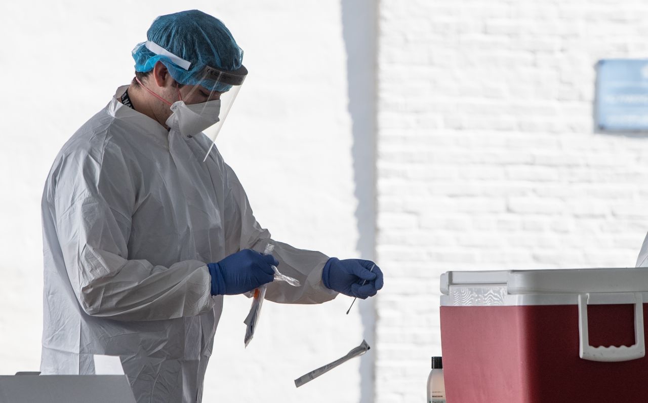 A nurse prepares to administer a COVID-19 test at a drive-through testing center at George Washington University in Washington, DC, on Thursday, May 7.