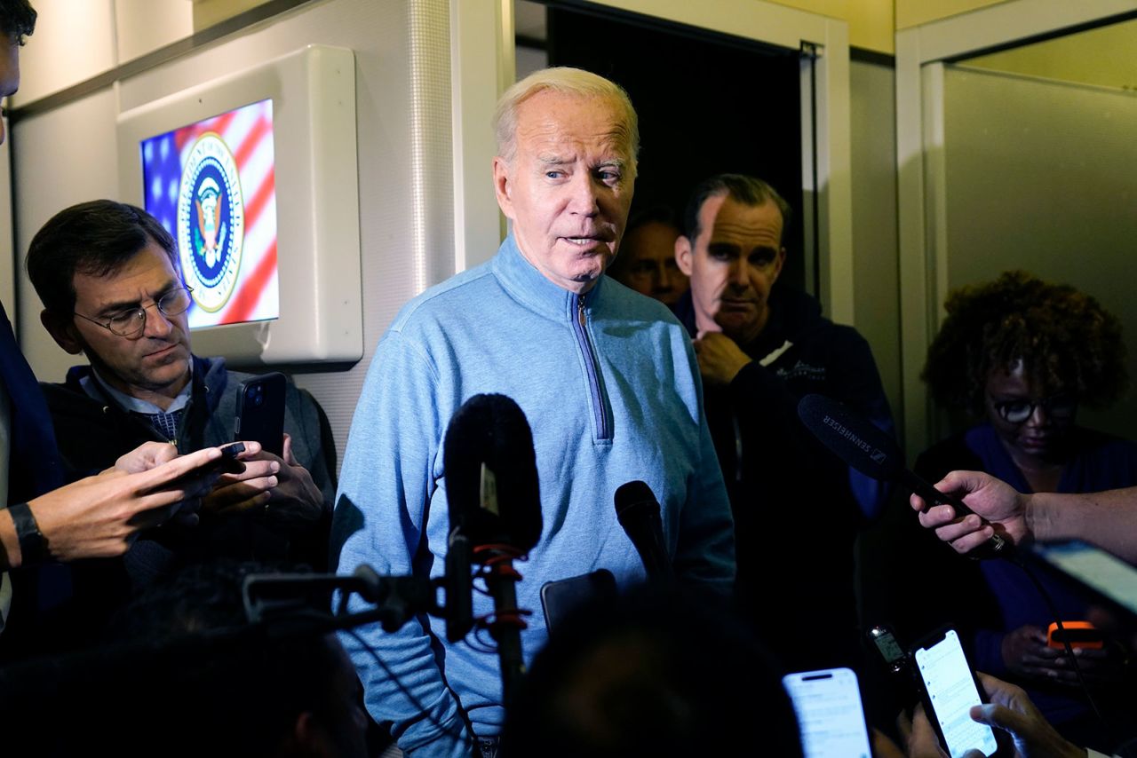 Biden speaks to the media on Air Force One during a refueling stop at Ramstein Air Base, Germany, Wednesday, October 18.