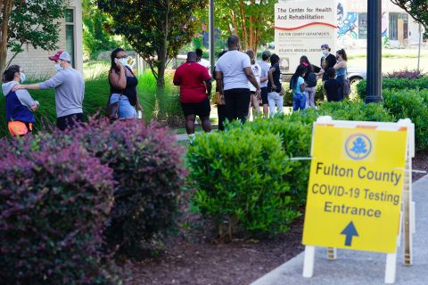 People stand in line to get tested for COVID-19 at a free walk-up testing site on July 11 in Atlanta, Georgia.