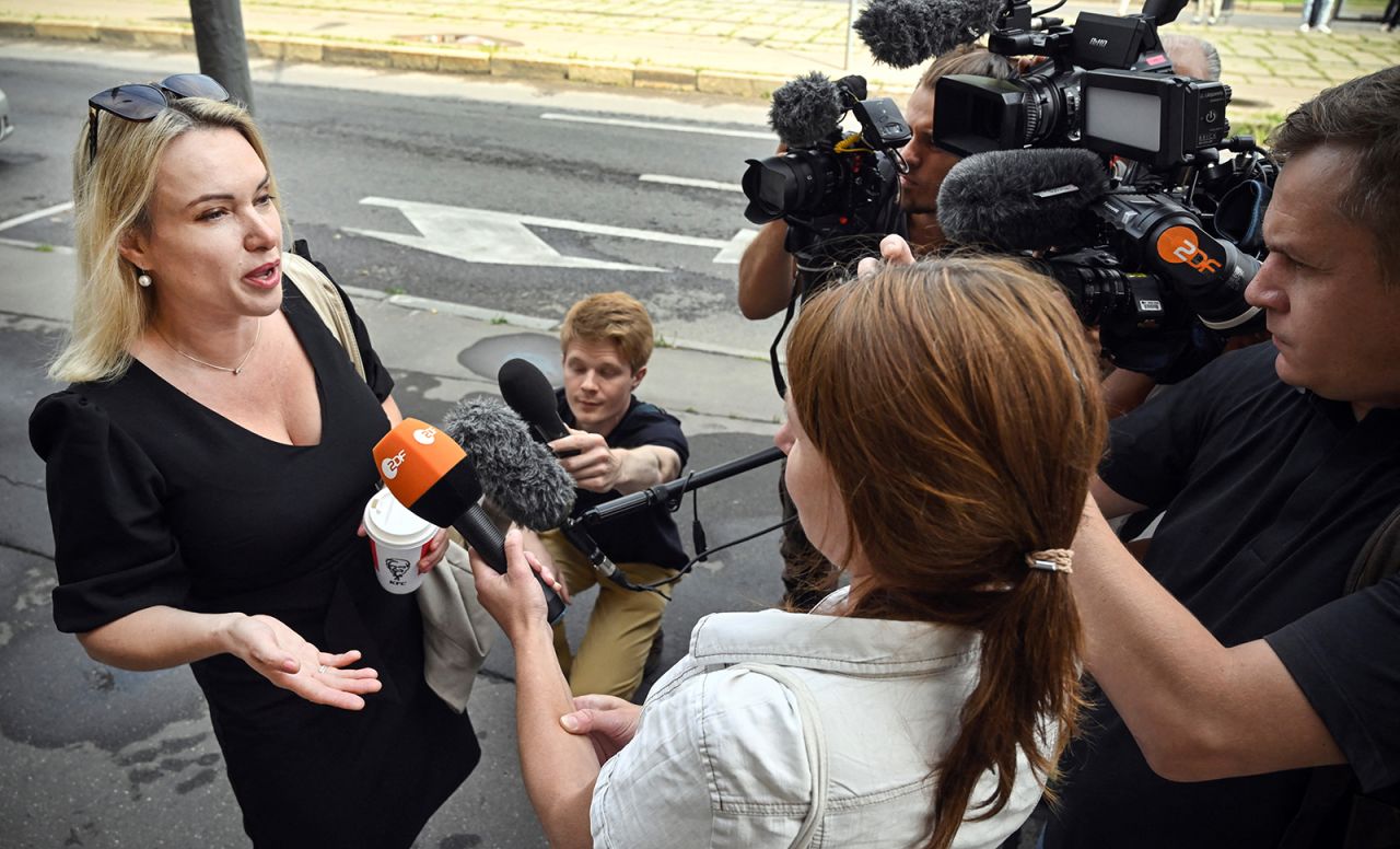 Journalist Marina Ovsyannikova answers journalists' questions as she arrives for court in Moscow on Aug. 8. 