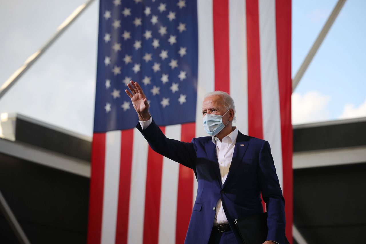 Democratic presidential nominee Joe Biden waves to supporters during a drive-in voter mobilization event at Miramar Regional Park on October 13 in Miramar, Florida. 