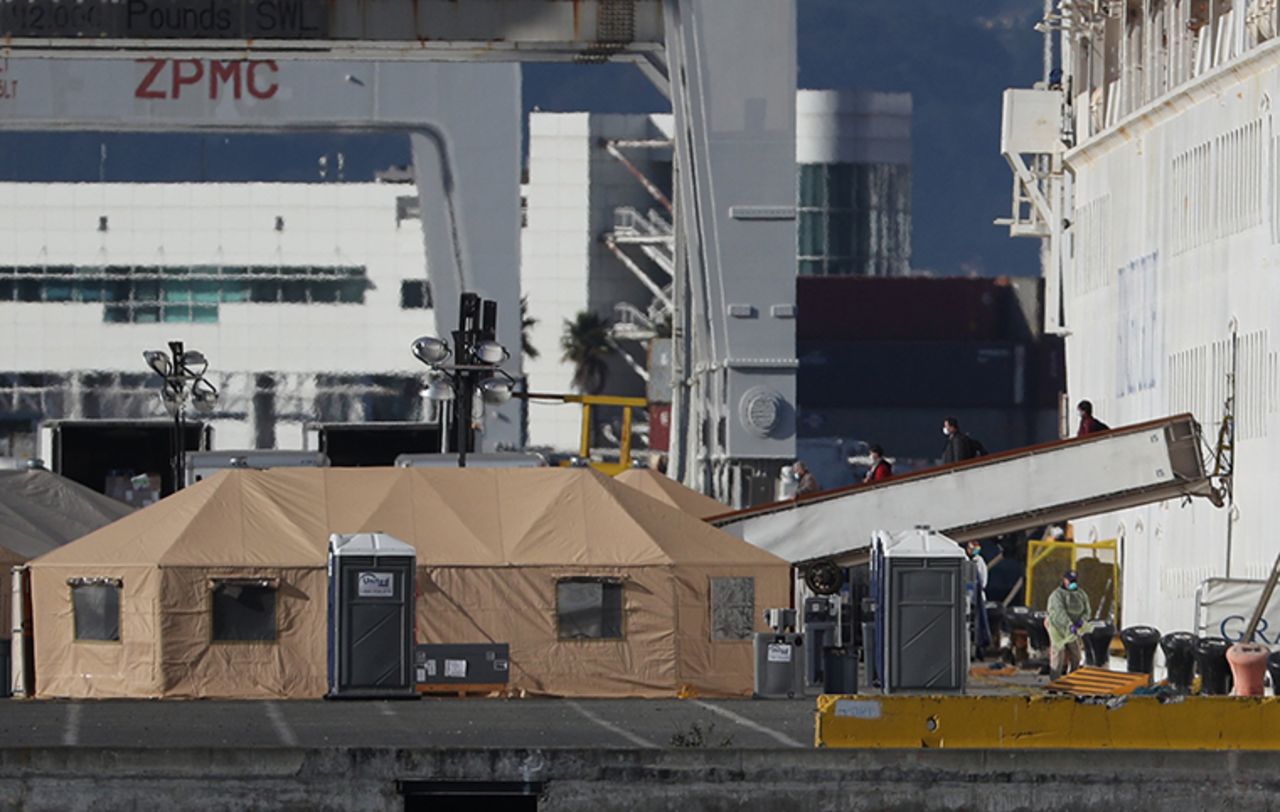 Passengers disembark from the Grand Princess cruise ship as it sits docked in the Port of Oakland on Tuesday, March 10.