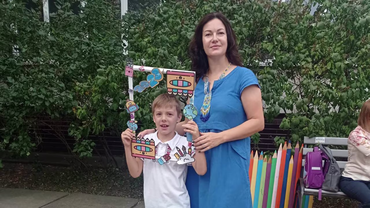 Kateryna Pylypenko pictured with her son on his first day of school on Friday.