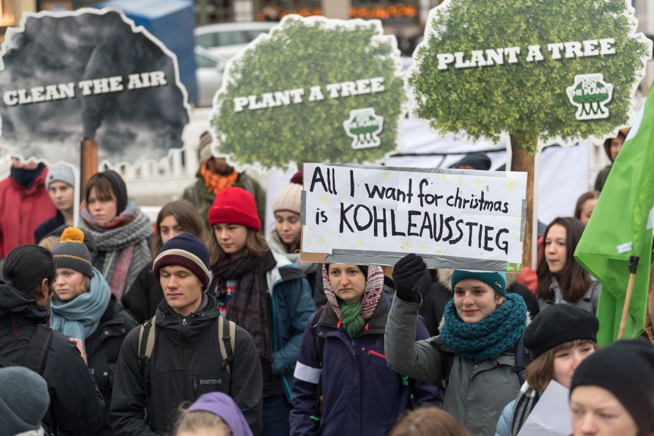 A girl holds a poster reading 'All I want for Christmas is coal phase-out' as she demonstrates with other students on December 14, 2018 in Berlin.