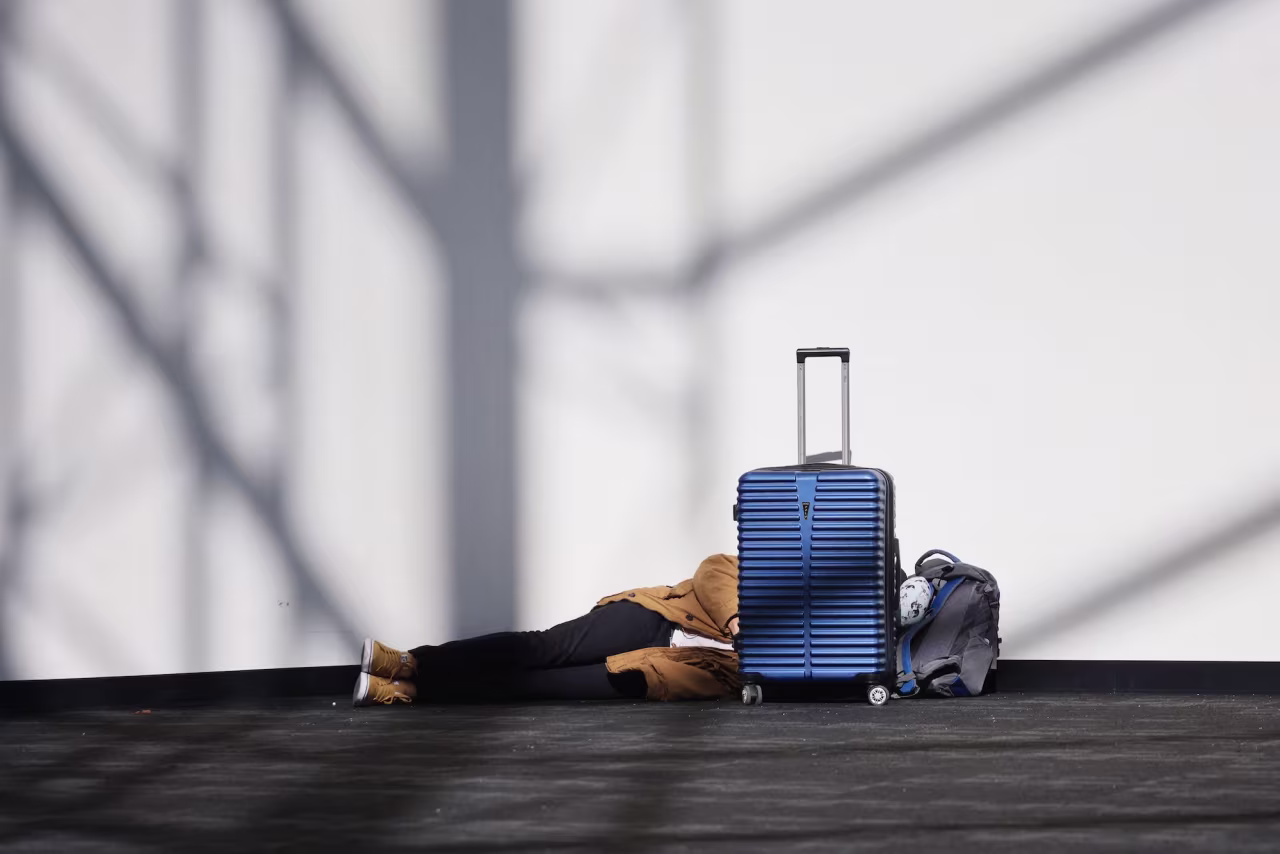 A person sleeps in a terminal at Los Angeles International Airport on Tuesday.