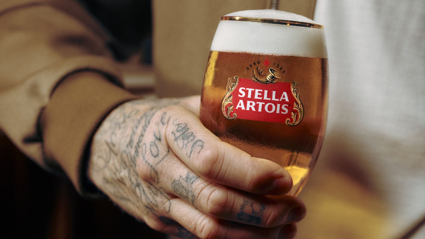 David Beckham holds a Stella Artois.
