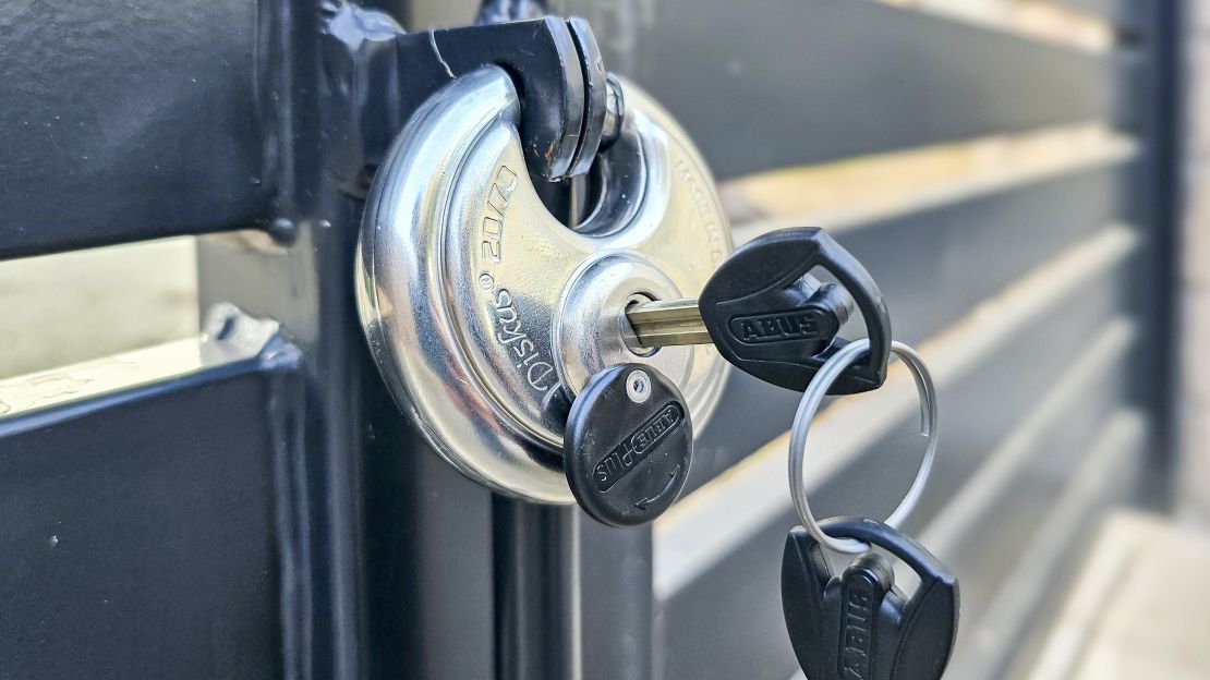 Abus Diskus 20/70 attached to a gate with its keys in the keyhole