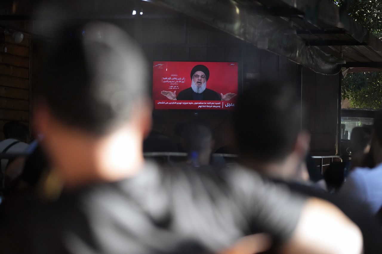 People watch the speech of Hezbollah leader Hassan Nasrallah on a TV screen as they sit in a cafe in the southern suburbs of Beirut, Lebanon, on September 19.